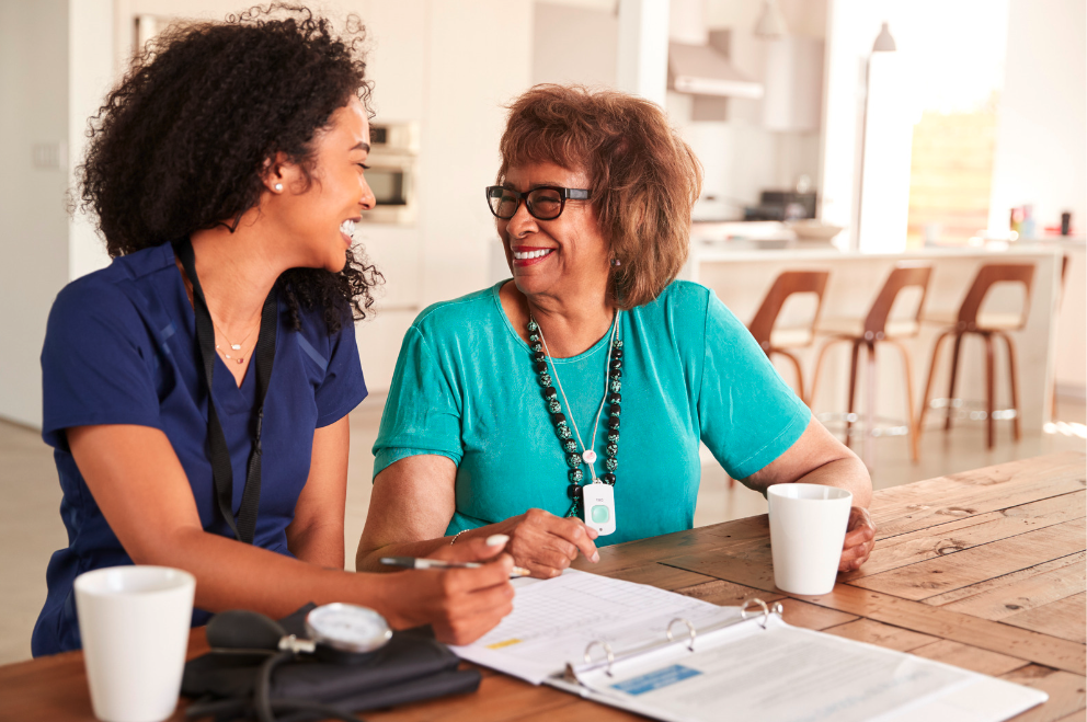 Nurse working with elderly woman to assist in healthcare IT